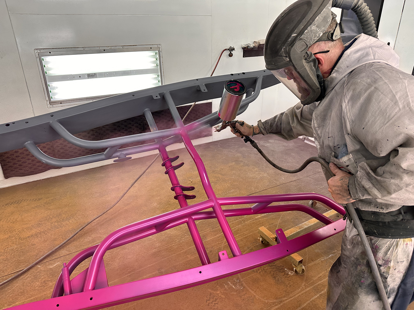 06 Bright pink finish being applied to the tubular frame emphasizing its bold custom design