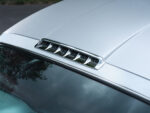 09 1958 Chevrolet Impala roof vent close up chrome accents streamlined design rain droplets enhance detail