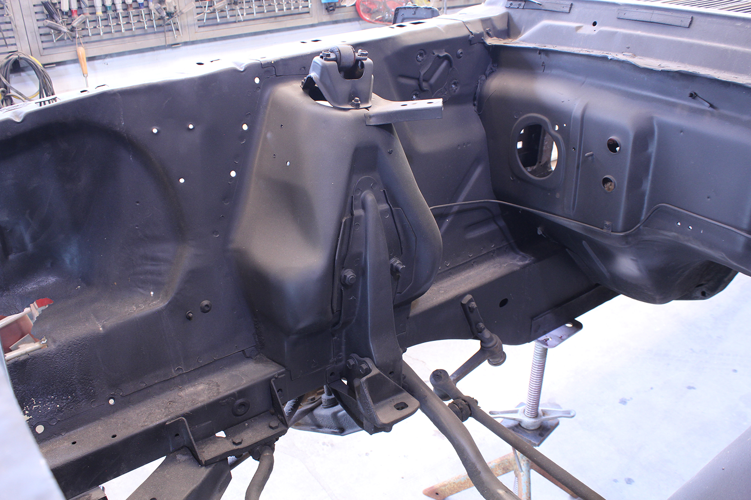 10 Stripped interior framework of 1965 Ford Mustang showing removed floor pan and structural preparation
