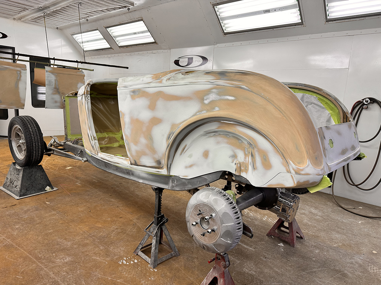 11 Bare metal 1932 Ford roadster body prepped for primer in a professional restoration booth