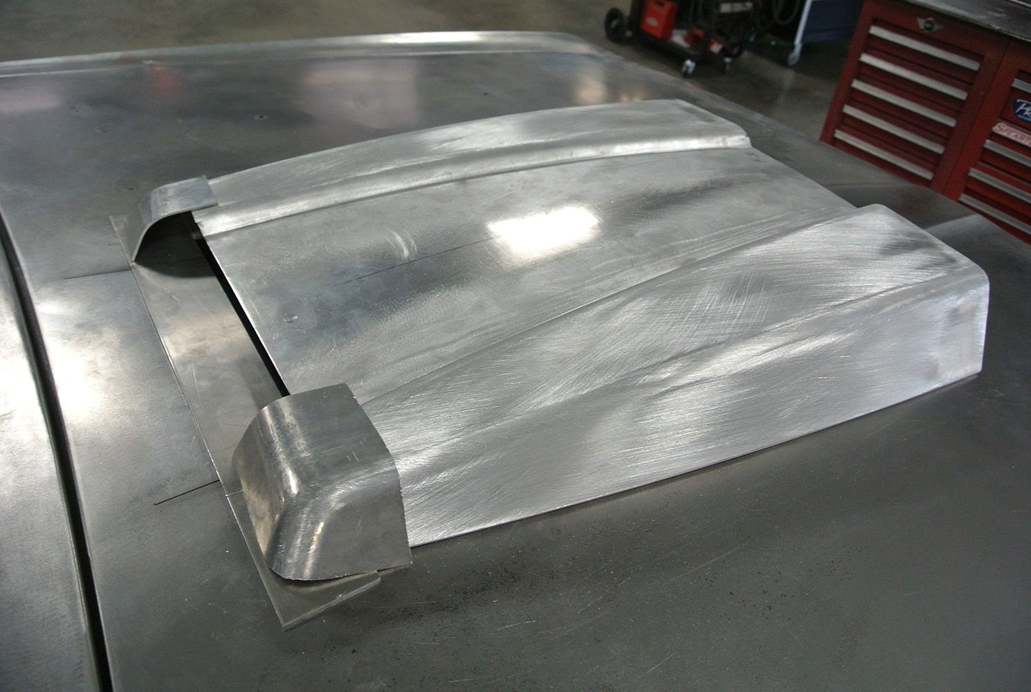 11 Brushed metal hood scoop design fitted on a custom project for added engine clearance and ventilation