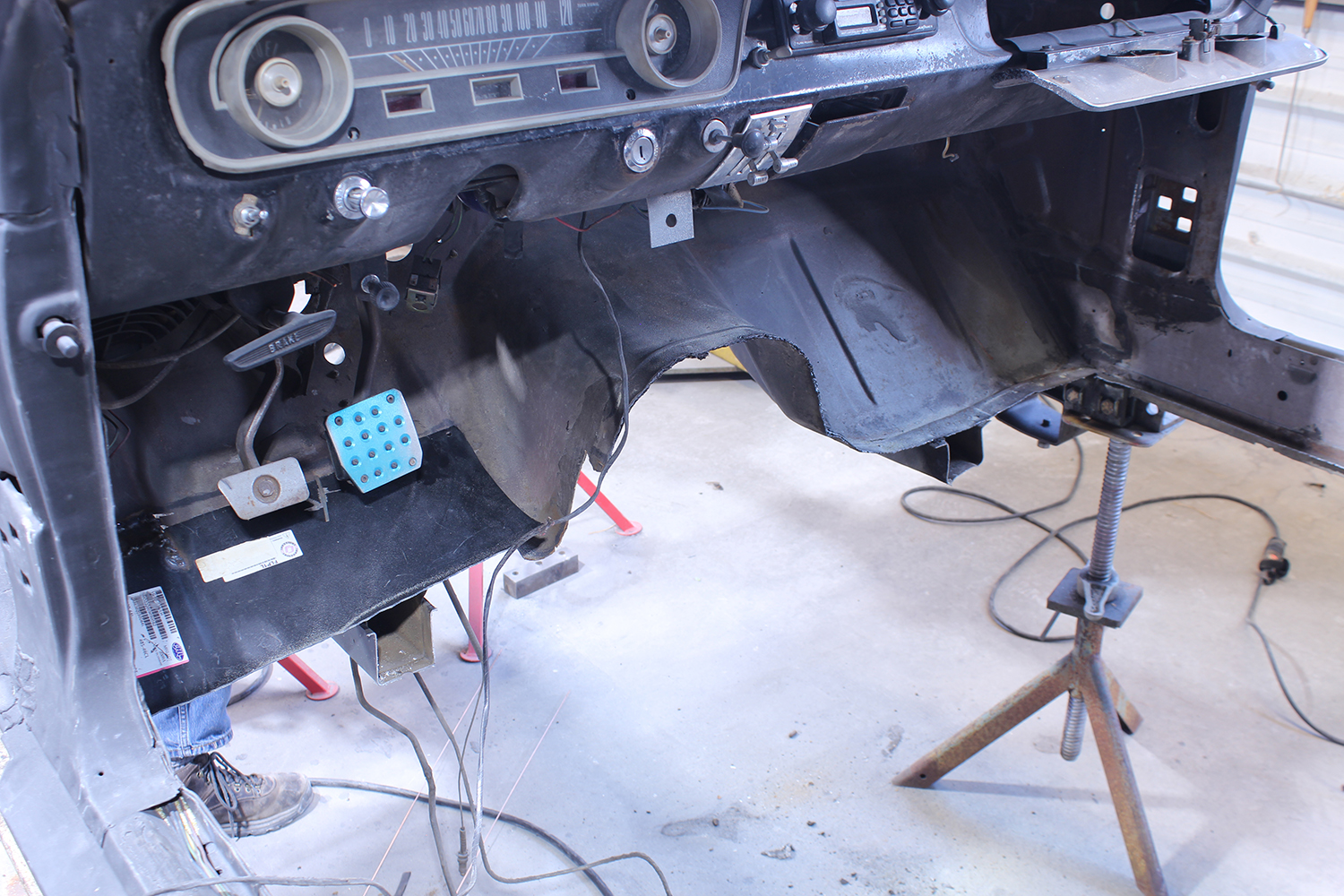 11 Dashboard and floor pan of 1965 Ford Mustang stripped showing extensive restoration work in progress