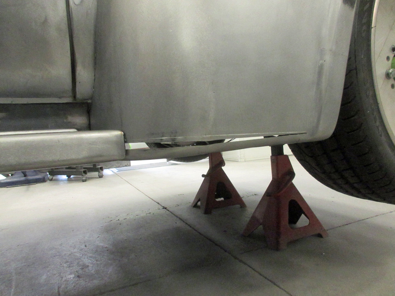 11 Ford F100 cab corner under restoration on jack stands