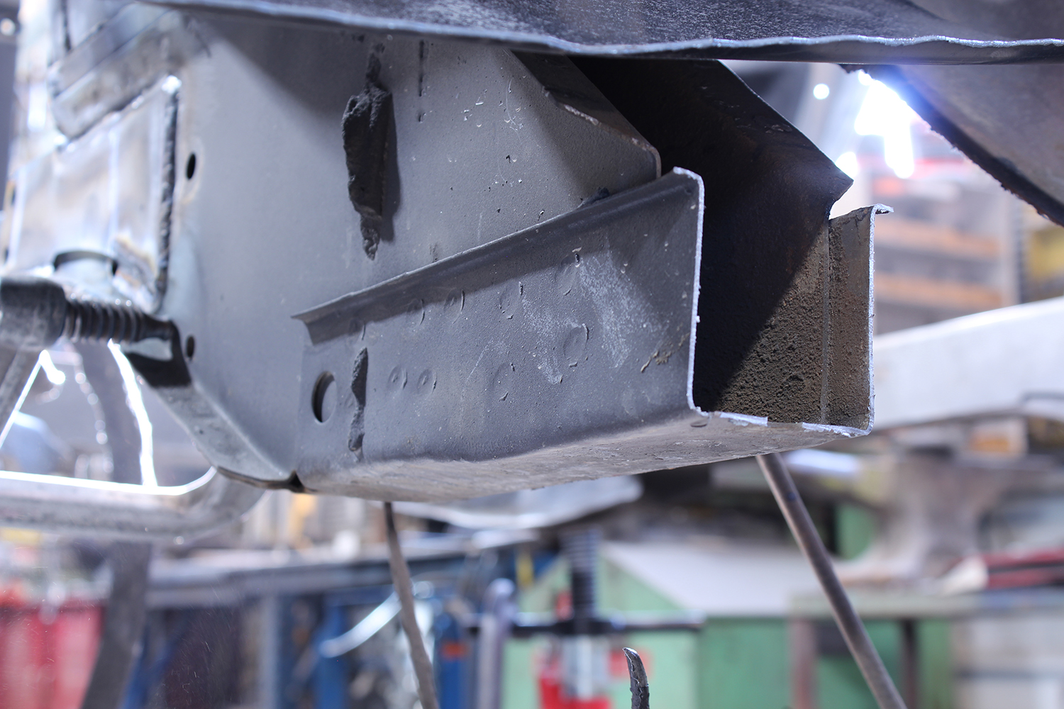 12 Close up of 1965 Ford Mustang frame rail during rust repair and metal patching