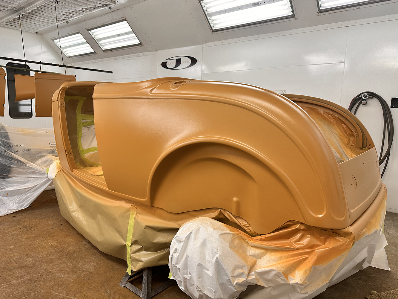 12 Roadster body coated with orange primer ready for sanding and additional layers of paint