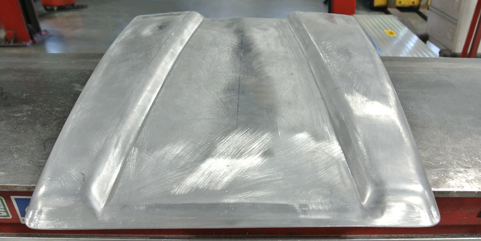 12 Smoothly fabricated hood scoop with defined edges and a clean brushed finish for a classic car build