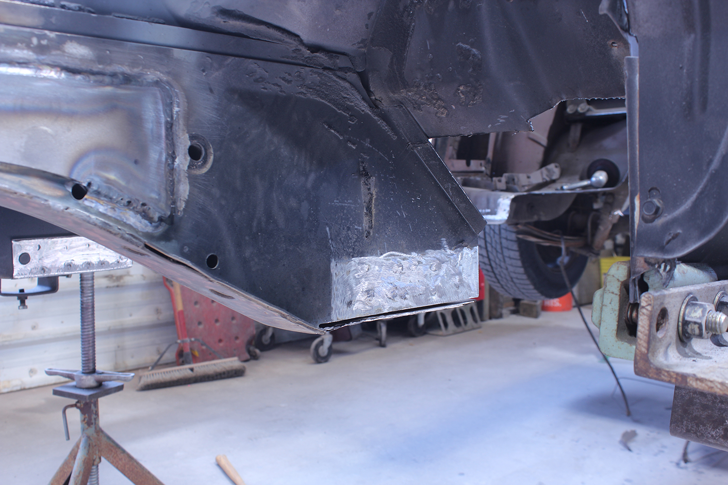 14 Newly welded frame rail repair on 1965 Ford Mustang showcasing precise restoration progress