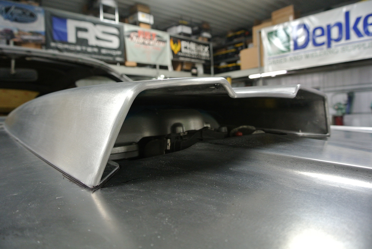 15 Side profile of a hood scoop showing functional clearance for high performance engine components
