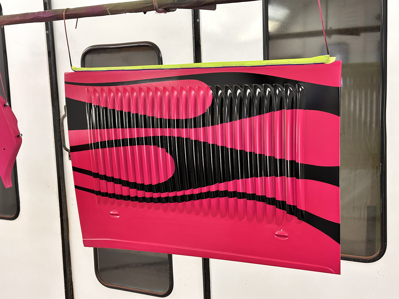 20 Completed hood panel featuring bold black flames over a hot pink base showcasing precise custom work