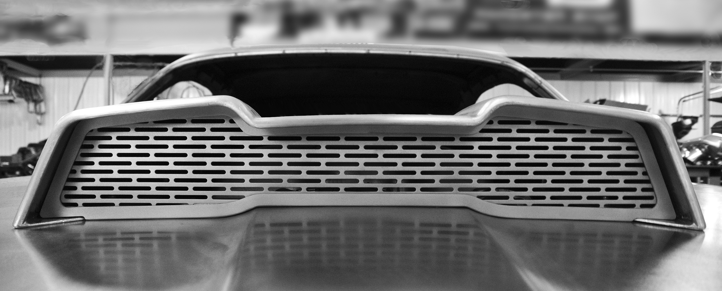 21 Custom fabricated hood scoop vent featuring a perforated metal grille for improved airflow and a sleek retro modern aesthetic