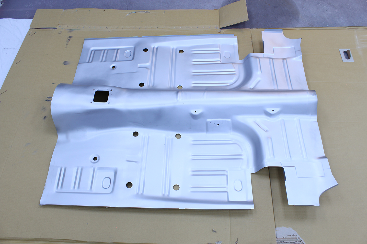 21 New floor pan for 1965 Ford Mustang prepared for installation with primed finish