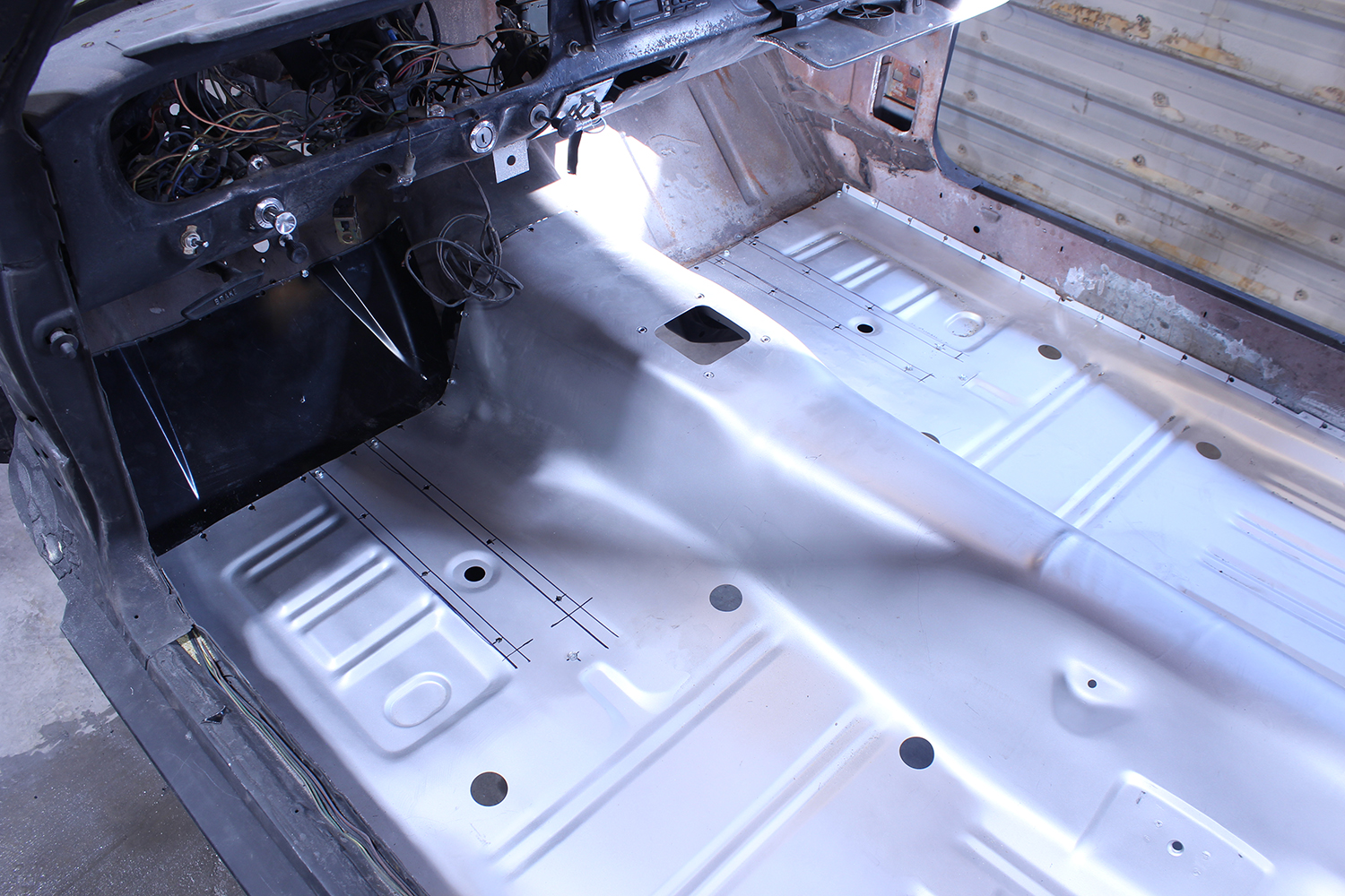 22 Floor pan fitted in 1965 Ford Mustang interior aligned for welding and securing