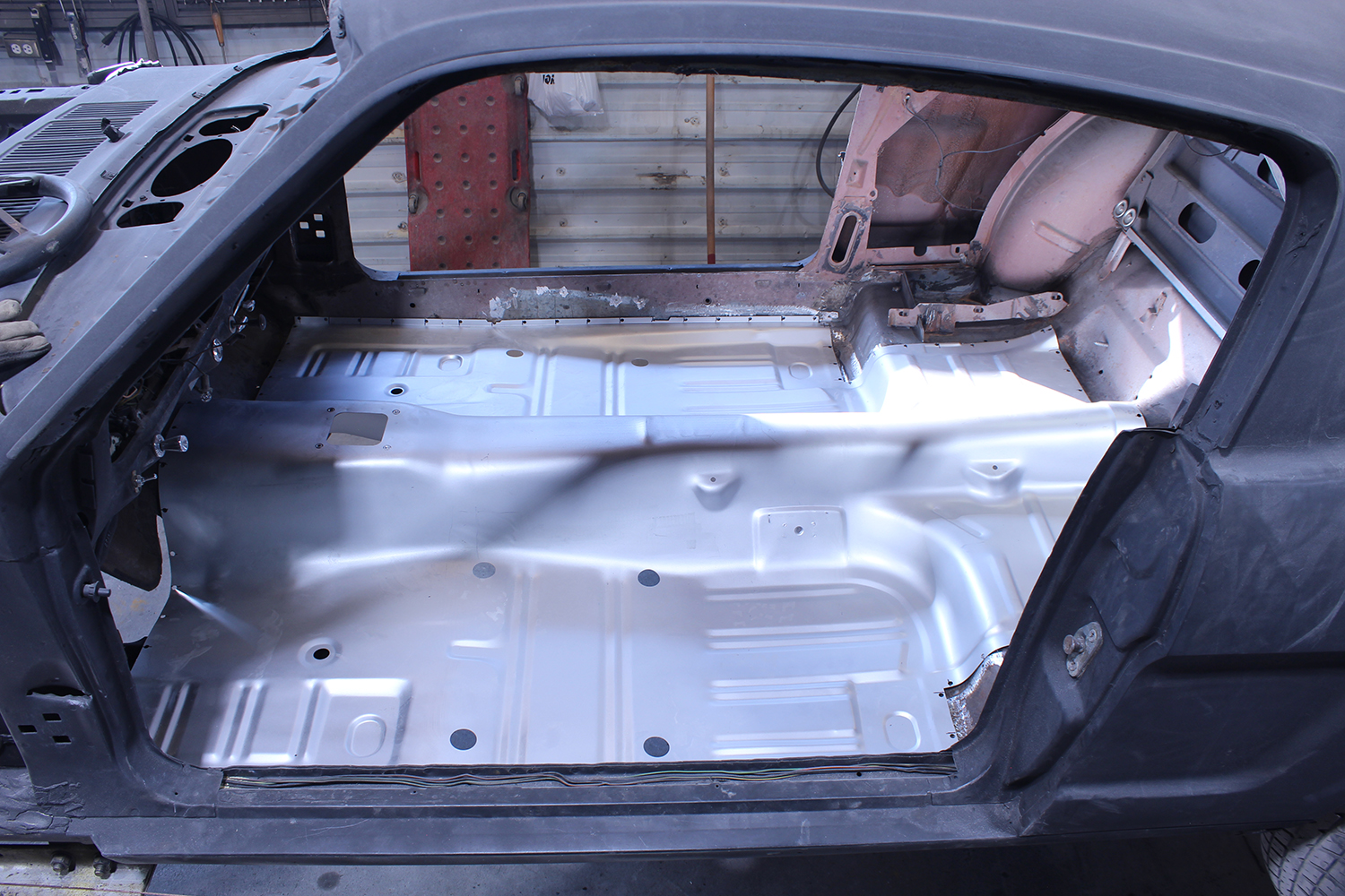 26 Full interior view of 1965 Ford Mustang with newly installed floor pan secured in place