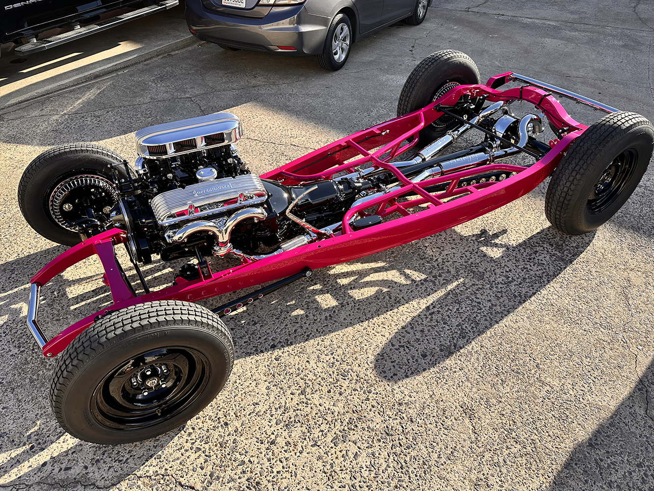 27 Roadster chassis painted pink with a fully assembled drivetrain and chrome components