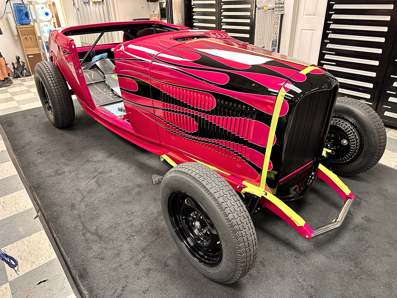 28 Nearly completed 1932 Ford roadster featuring striking pink and black flames ready for final assembly