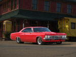 001 1965 Chevrolet Impala Super Sport red parked near a vintage train station custom wheels restored exterior