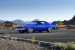 001 1969 Chevrolet Camaro in stunning blue custom wheels set against a scenic desert backdrop