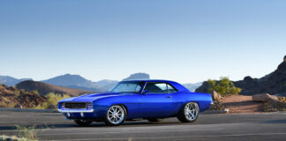 001 1969 Chevrolet Camaro in stunning blue custom wheels set against a scenic desert backdrop