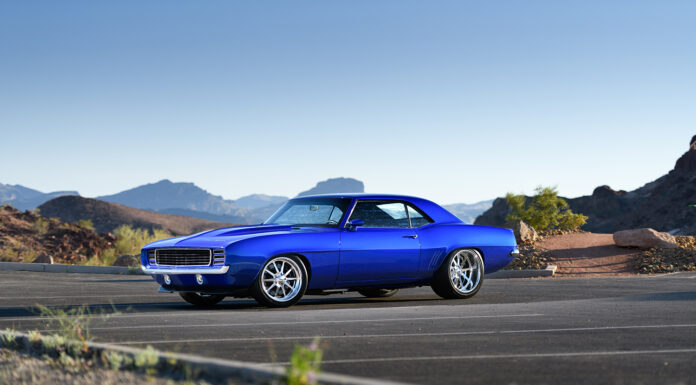 001 1969 Chevrolet Camaro in stunning blue custom wheels set against a scenic desert backdrop