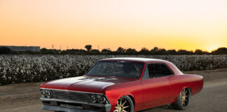 002 1966 Chevrolet Chevelle at sunset showcasing a deep red paint job modern aero enhancements and wide tires for maximum grip