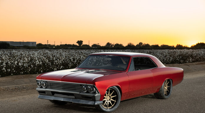 002 1966 Chevrolet Chevelle at sunset showcasing a deep red paint job modern aero enhancements and wide tires for maximum grip