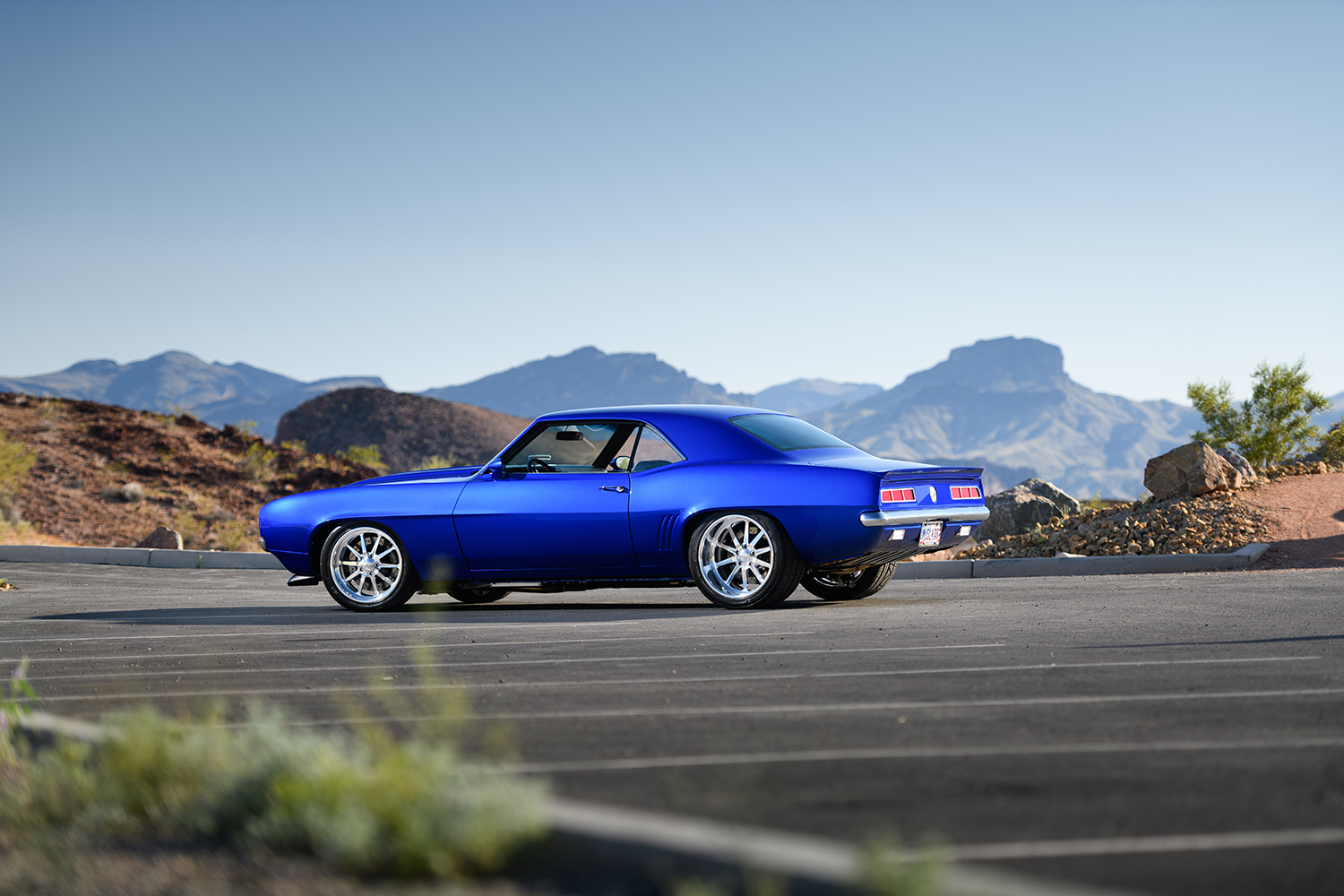002 1969 Chevrolet Camaro rear three quarter view showcasing sleek body lines chrome accents and dual exhausts