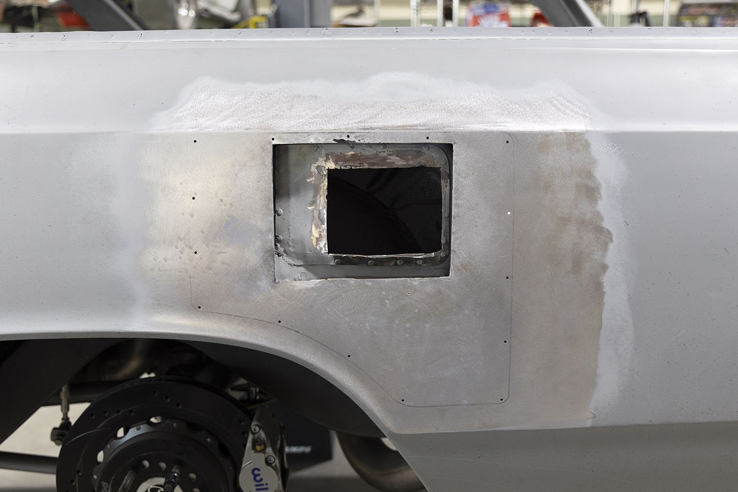 002 Close up of the cut out fuel door area revealing bare metal and precise weld marks for the modification