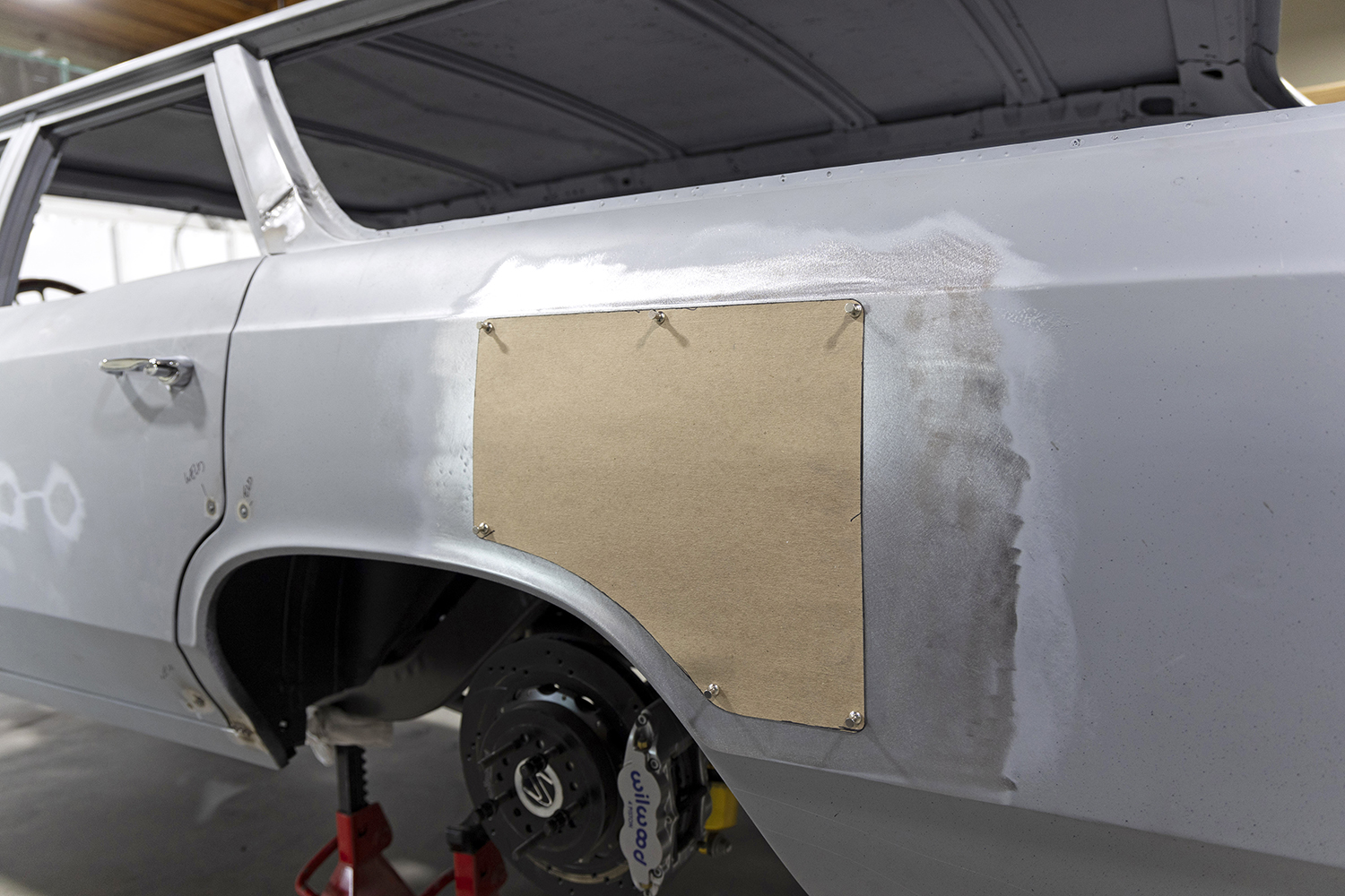 003 Cardboard template is secured to the quarter panel outlining the custom patch panel shape before fabrication