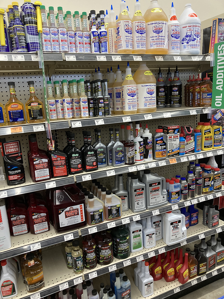 003 Store shelf filled with various motor oil additives and engine treatment products from popular brands