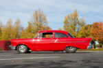 004 1957 Chevrolet Bel Air side profile showcasing bright red paint classic fins and a lowered hot rod stance