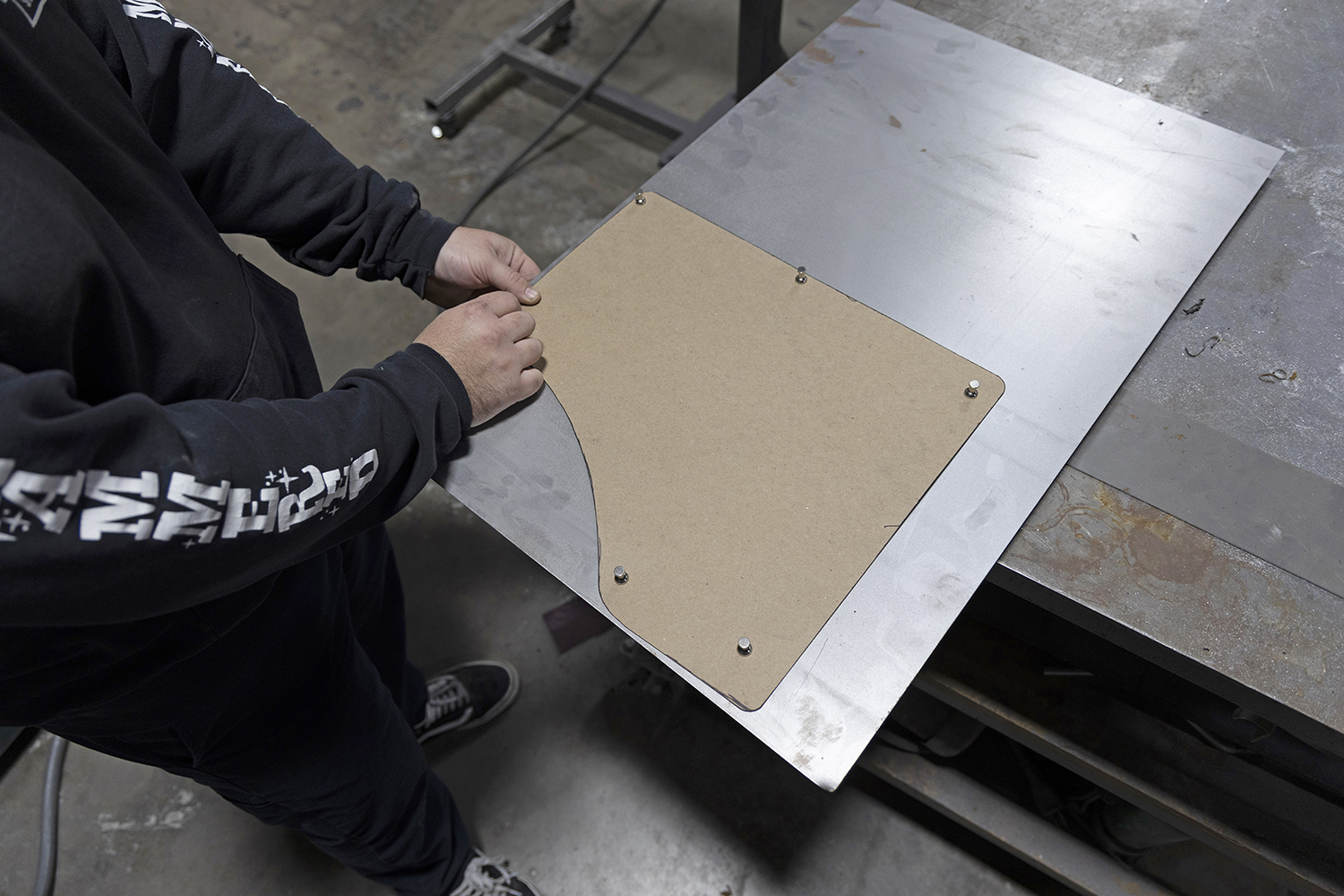 004 Cardboard template is placed on a sheet of metal ready to be traced and cut for the replacement panel