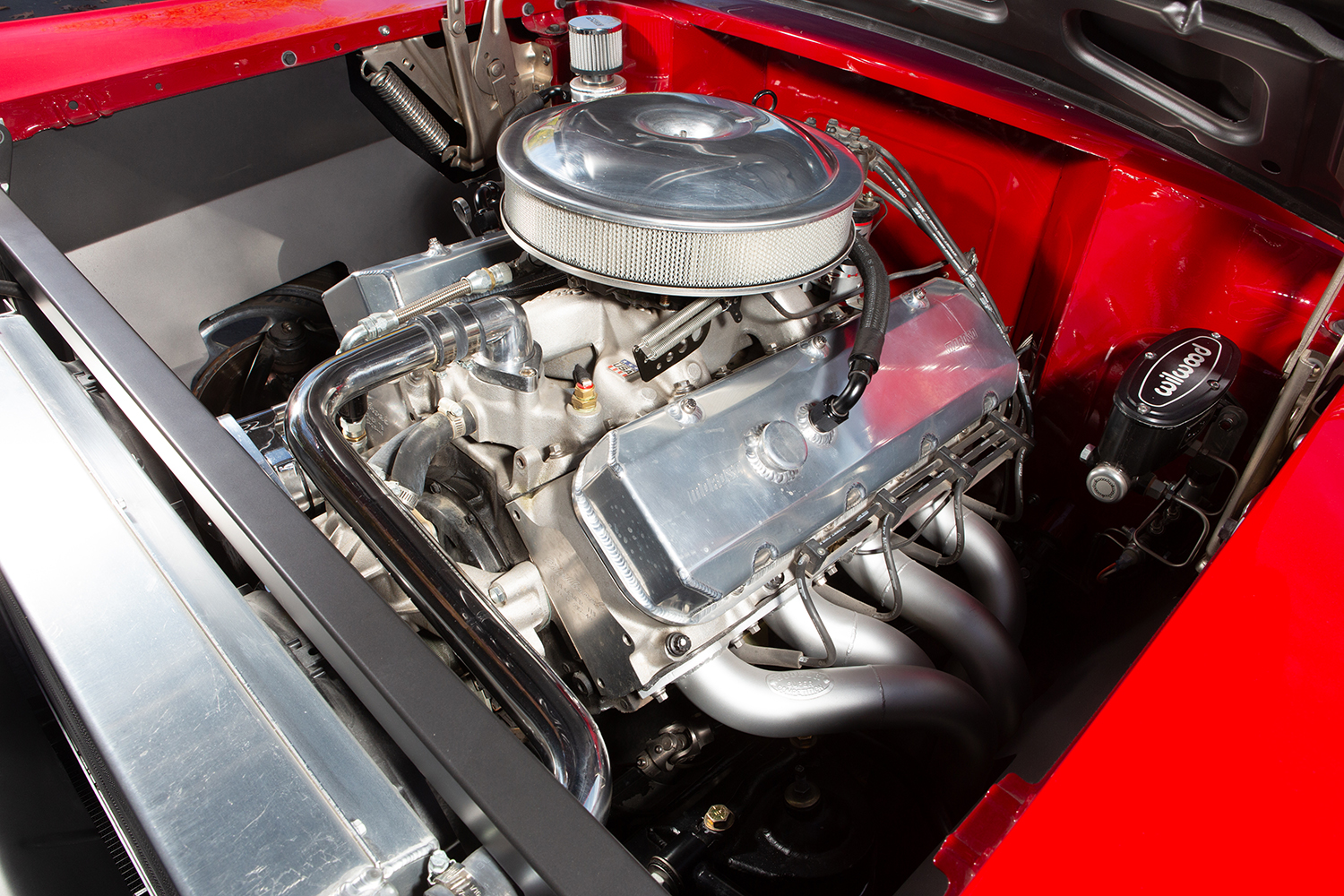 005 1957 Chevy High performance engine bay featuring an aluminum intake manifold polished headers and Wilwood master cylinder