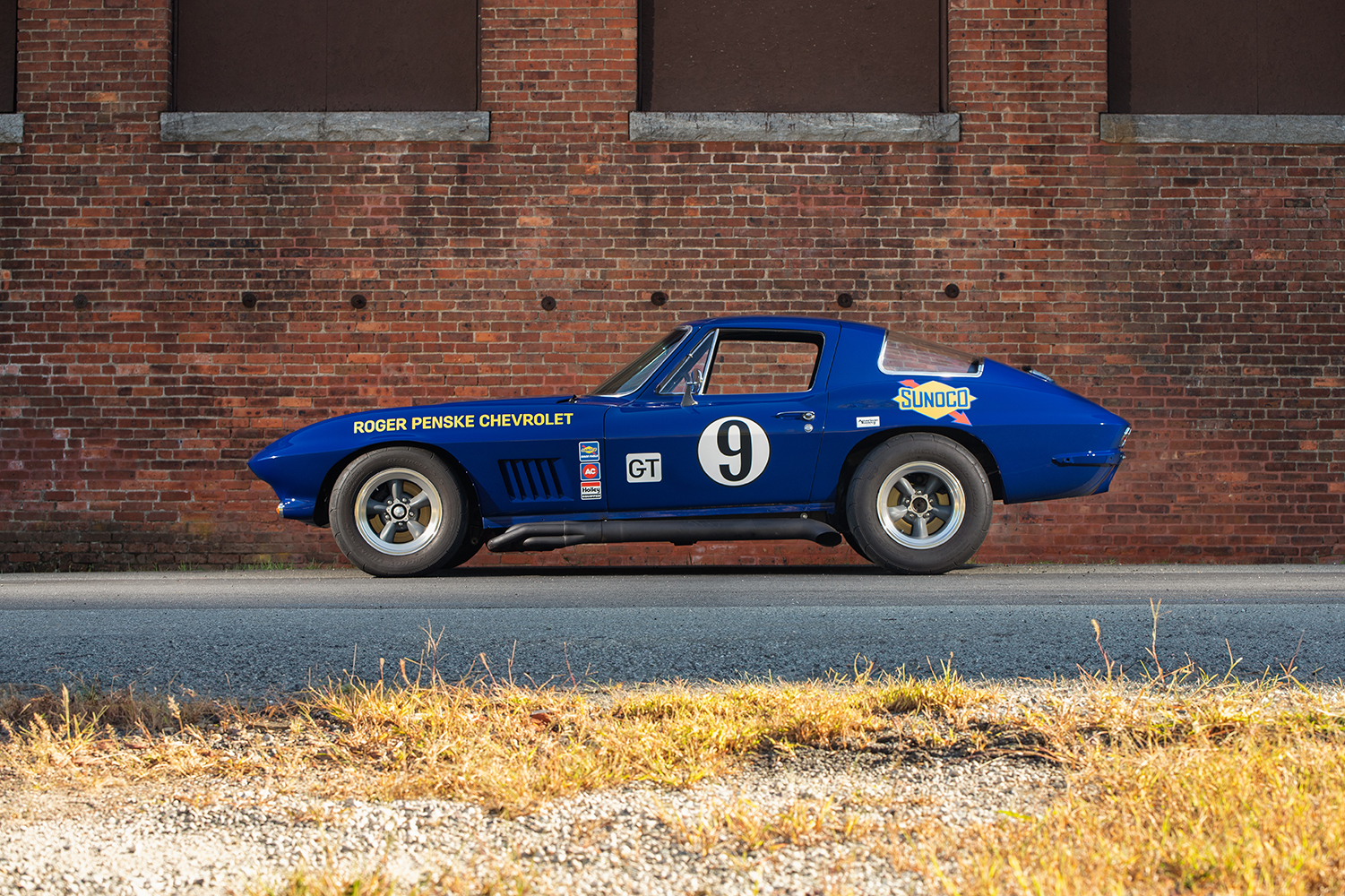 005 1966 Chevrolet Corvette front view blue showcasing hood scoop grille and headlight details with a racing stance