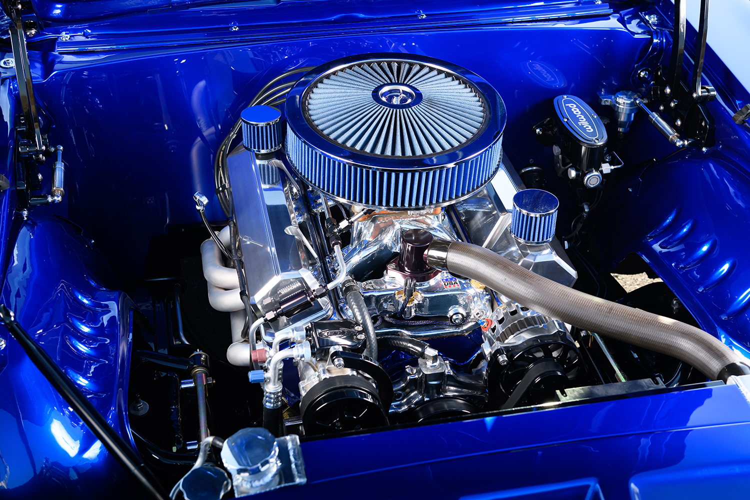 005 1969 Chevrolet Camaro engine bay featuring polished components blue accents and a high performance air intake