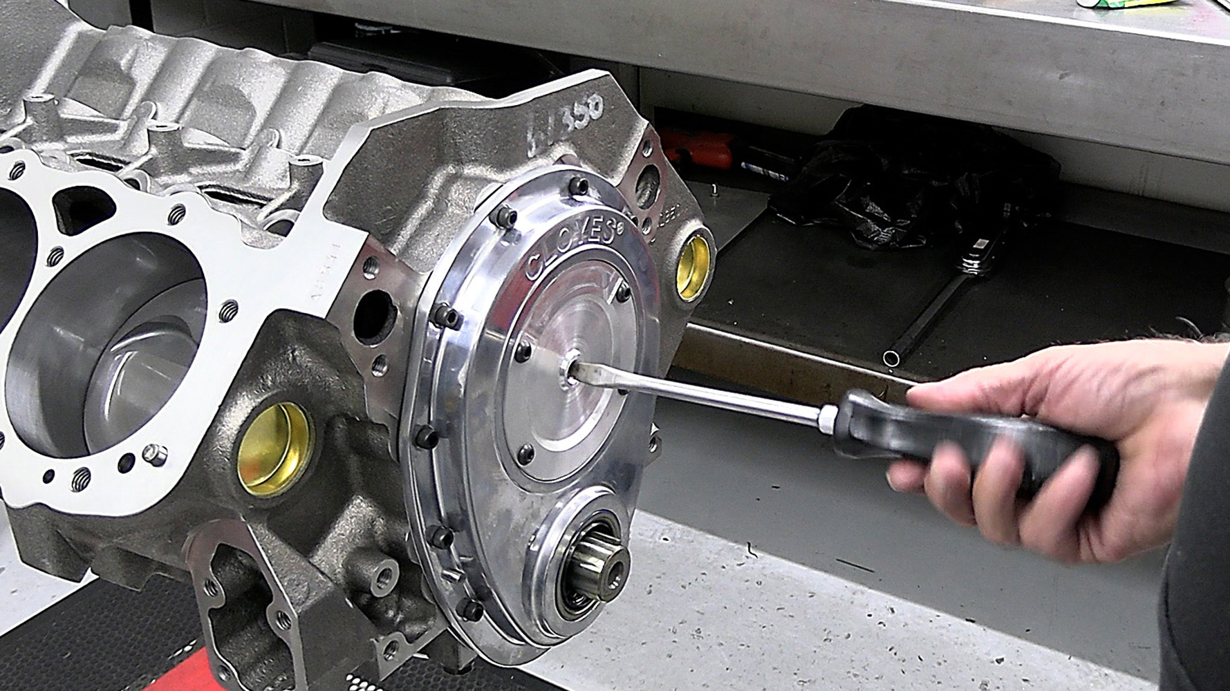 005 Polished front timing cover being secured on the 424 small block engine block