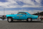006 1966 Chevrolet Nova Gasser side profile showing its elevated front suspension and drag race detailing
