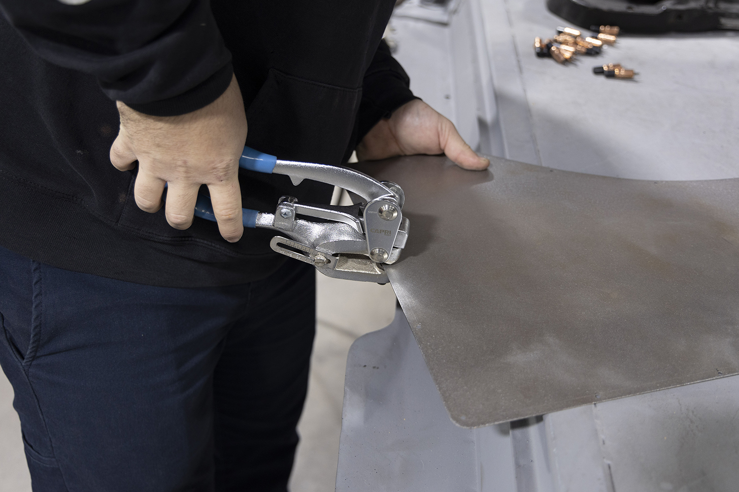 006 Fabricator uses hand shears to refine the edges of the new patch panel for a seamless installation