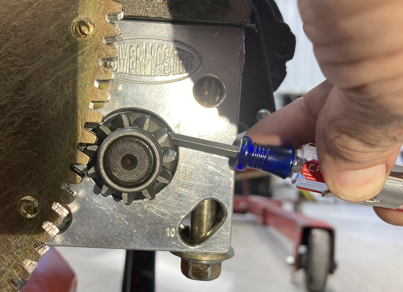 006 Pinion gear engagement verified with a screwdriver for proper alignment