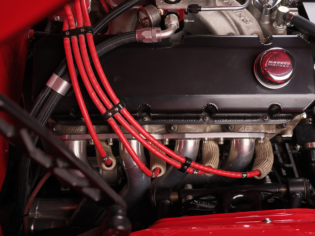 007 1965 Chevrolet Impala SS close up of engine AFR heads red ignition wires and polished Moroso valve covers