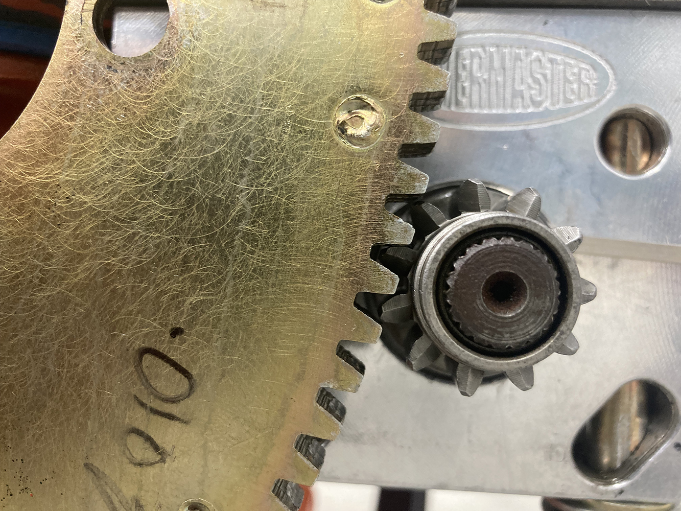 007 Close up of starter pinion gear and flywheel teeth meshing for proper engagement