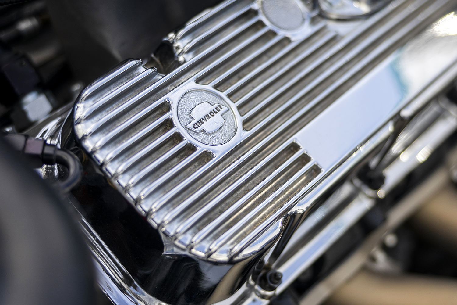 008 1966 Chevy Nova engine with polished Chevrolet branded valve covers featuring finned aluminum design for classic style and performance