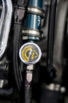 009 1966 Chevrolet Nova Gasser close up of oil pressure gauge with braided fuel lines and high performance fittings