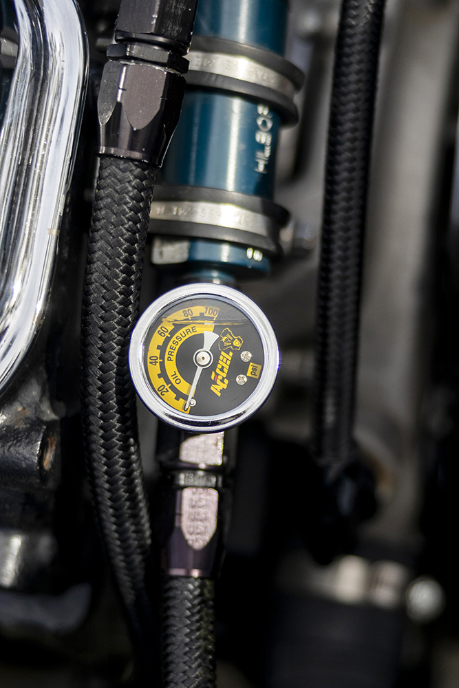 009 1966 Chevrolet Nova Gasser close up of oil pressure gauge with braided fuel lines and high performance fittings