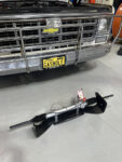 00A Power rack and pinion steering conversion kit in front of a 1980s Chevrolet truck