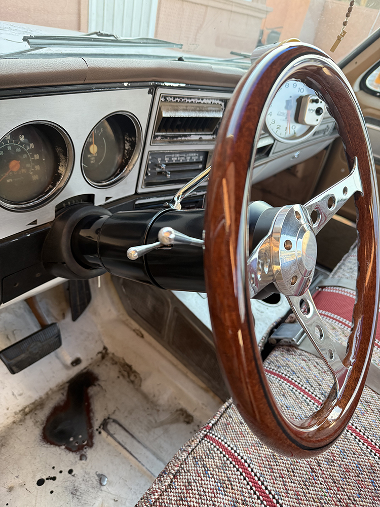 00B Custom wood rimmed steering wheel and aftermarket tachometer in a classic Chevy truck interior