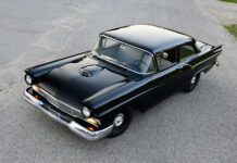 01 1957 Ford Custom with deep black paint hood scoop and chrome bumper captured from a high angle