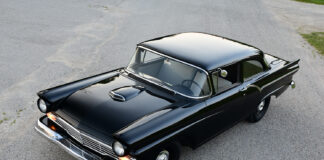 01 1957 Ford Custom with deep black paint hood scoop and chrome bumper captured from a high angle