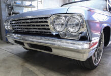 01 A restored 1962 Chevy Impala with a gleaming chrome grille and quad headlight design