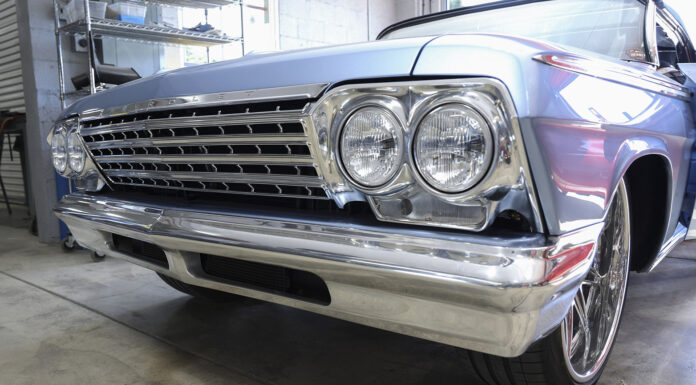 01 A restored 1962 Chevy Impala with a gleaming chrome grille and quad headlight design