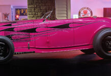 01 Hot pink 1932 Ford Roadster with black flame graphics steel wheels and a vintage custom stance